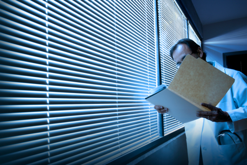 Doctor with a folder by a blind