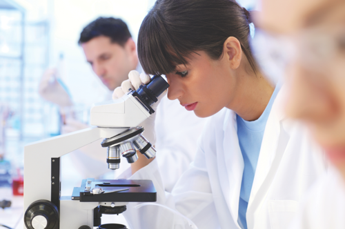 Woman looking into microscope